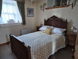 a bedroom with a large bed and a window at Kilfinichen Church in Kilfinchen