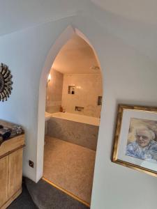 a bathroom with a shower and a tub and a picture at Kilfinichen Church in Kilfinchen