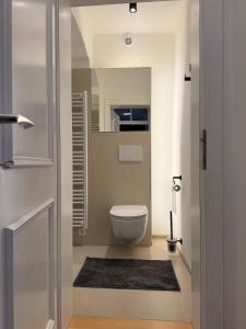 a small bathroom with a toilet and a mirror at Yellow House Apartments - Top 3 in Steyr +32 photos
