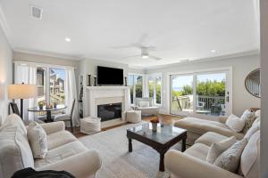 a living room with white furniture and a fireplace at DS1113: 1113 Duneside Drive in Kiawah Island