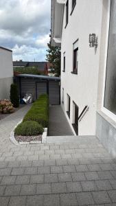 a white building with a driveway and a garage at LembergLodge Gosheim in Gosheim