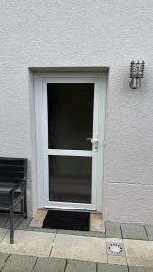 a door with a glass window next to a building at LembergLodge Gosheim in Gosheim