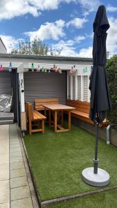 a patio with a wooden table and a umbrella at LembergLodge Gosheim in Gosheim