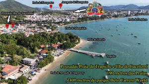 an aerial view of a beach with a carnival and a resort at Pousada Ilha do Itacolomi Com Piscina Proximo do Beto Carrero in Penha