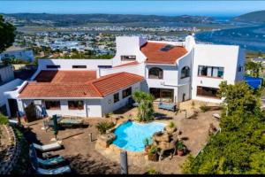 an aerial view of a house with a swimming pool at Pamosoro Pegomo Villa - Luxurious Knysna Views! in Knysna