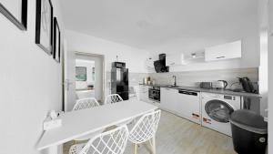 a white kitchen with a sink and a washing machine at Yellow one in Magdeburg