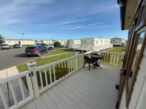 a deck with a grill and a car parked on it at Skegness Retreats The Grange F59 in Ingoldmells