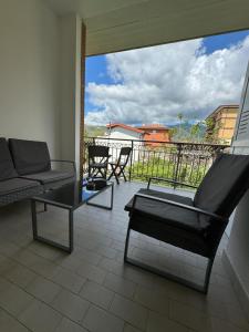a living room with a couch and chairs on a balcony at LIKE HOME in Norma