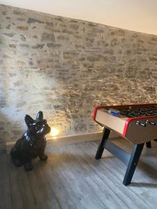 a room with a ping pong table next to a wall at Le Numéro 2 in Ornans