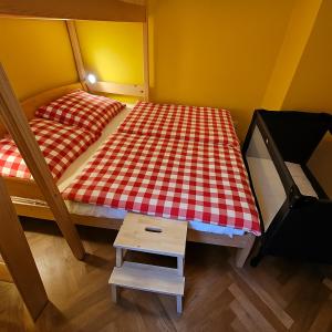 a small bedroom with a bed and a small table at Rodinný apartmán Pec pod Sněžkou 3 - 1x parking available in Pec pod Snezkou