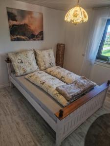 a bed in a room with a couch at Ferienwohnung Osterberg in Unterthingau