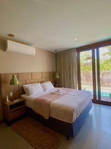 Ένα ή περισσότερα κρεβάτια σε δωμάτιο στο Luxo, Conforto & Piscina no Refúgio do Igarapé +29 φωτογραφίες