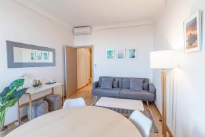 a living room with a couch and a table at T2 central Beausoleil in Beausoleil