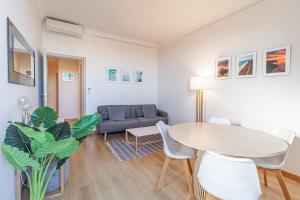 a living room with a table and a couch at T2 central Beausoleil in Beausoleil