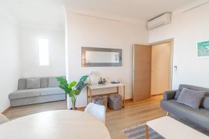 a living room with a couch and a table at T2 central Beausoleil in Beausoleil