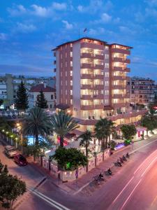 a large building on a city street at night at May Flower Apart Hotel in Alanya