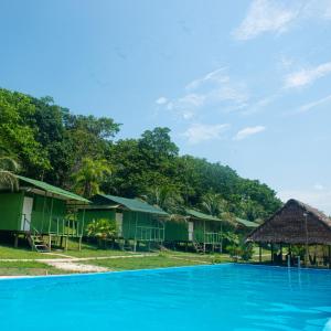 a resort with a large blue swimming pool at Maniti Eco-Lodge in Francisco de Orellana