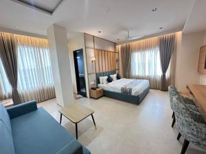 a hotel room with a bed and a couch at lotusinn in Bānswāra