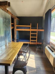 a room with a table and chairs and bunk beds at Relaxing Group Cabin with Fire Ring in Indiana in Stony Lonesome