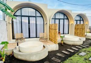 a house with two large windows and two chairs at Pinggan heaven in Gretek +32 photos