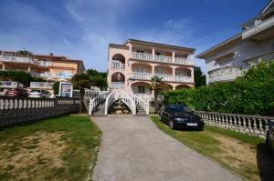 a car parked in front of a pink building at Room in Lopar with Balcony, WIFI 4620-95 in Lopar +28 photos