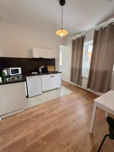 a kitchen with white cabinets and a counter top at Green 3 - Roubaix Gare in Roubaix