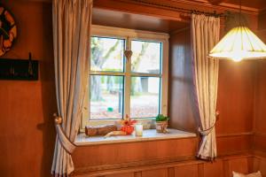 a window in a room with a table and a light at Brauereigasthof Gut Forsting in Pfaffing