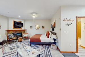 a hotel room with a bed and a fireplace at Main Street Station #1210 in Breckenridge