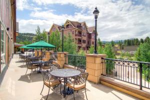 a patio with tables and chairs on a balcony at Main Street Station #1210 in Breckenridge