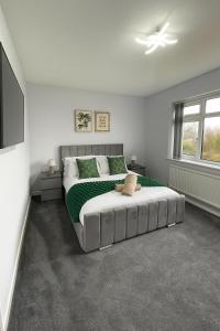 a bedroom with a large bed and a television at Luxury Airport Home with Driveway and Garden- Sleeps 7 in Ashley