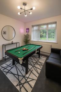 a living room with a pool table and a couch at Luxury Airport Home with Driveway and Garden- Sleeps 7 in Ashley