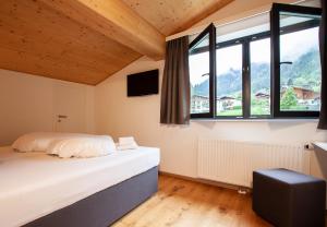Ένα ή περισσότερα κρεβάτια σε δωμάτιο στο Chalet Resort Montafon -Kollin & Cirrus-