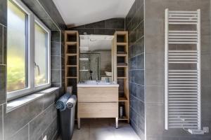 a bathroom with a sink and a mirror at L'Orée du Bois - Avec Jardin in Rouvroy-sur-Serre +18 photos