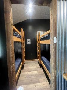 a room with three bunk beds in a building at Relaxing Group Cabin with Fire Ring in Indiana in Stony Lonesome +9 photos
