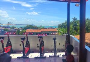 a gym with exercise equipment on the roof of a building at Shantti House in Pipa