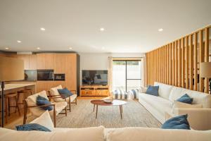 a living room with a couch and a table at Carvalhal Beach House in Carvalhal