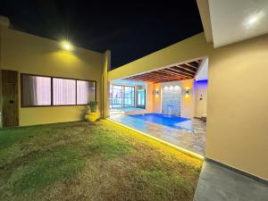 a house with a swimming pool in a yard at VIP Djuba Guest in Fombeni