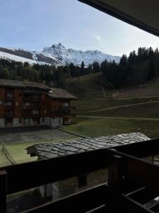 a view of a tennis court from a window at Les Traverses 18 in Valmorel +2 photos