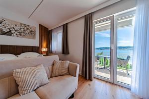 a bedroom with a couch and a large window at Bed & Breakfast Villa Vrgorac in Orebić +285 photos