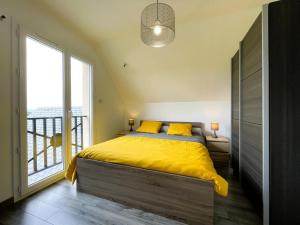 a bedroom with a yellow bed and a large window at Gite l'oree du bois in Livron +23 photos