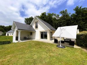 a white house with a large lawn in front of it at Gite l'oree du bois in Livron