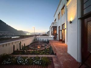 a view of a building with a courtyard with cactus at Axminster House in Muizenberg