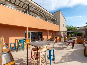 a group of tables and chairs outside of a building at Vacancéole - Les Demeures Torrellanes - Saint-Cyprien in Saint-Cyprien