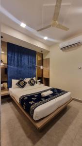 a large bed in a room with a ceiling at hotel beachfront in Calangute +16 photos