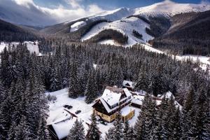 a house covered in snow in a snowy mountain at Hotel Mikulášska Chata in Belá +72 photos