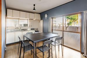 a kitchen with a table and chairs in a room at まほら in Fukuoka
