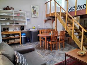 a living room with a table and a kitchen at Suites on 74 in Worcester