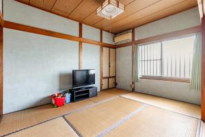 a living room with a flat screen tv and a window at まほら in Fukuoka +23 photos