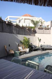 a patio with chairs and a swimming pool at מעגל השמש in Poriyya Illit
