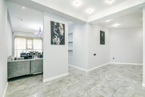 a living room with white walls and a couch at Lux Apartment View Baku Formula 1 Street in Baku